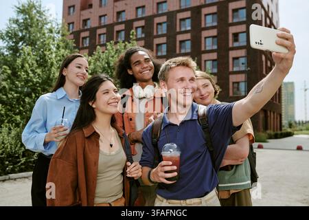 Diverse Group of Happy Students Taking Selfie on University Campus Stock Photo