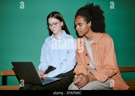 Diverse Students Studying Together on Laptop in University Campus Stock Photo