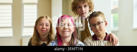 Portrait of Diverse Group of Children Smiling in Classroom Stock Photo
