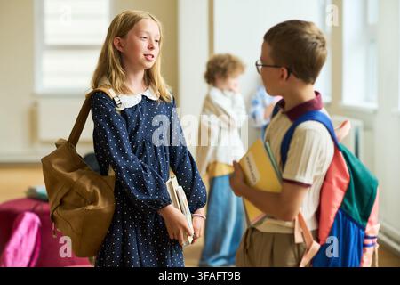 Schoolchildren Talking in Hallway during Break in Elementary School Stock Photo