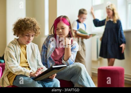 School Children Using Digital Tablet in Classroom Hallway Stock Photo