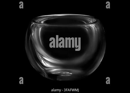 Empty glass tea bowl isolated on black background Stock Photo