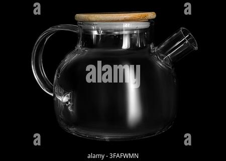 Empty glass teapot with bamboo lid isolated on black background Stock Photo