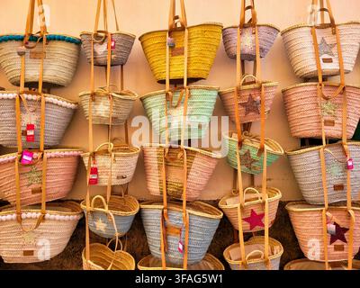 Traditional Woven Straw Beach Bags Hanging at Street Market in Mallorca Stock Photo