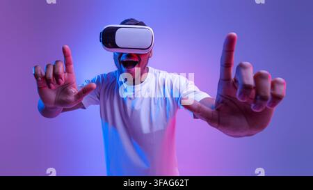 Happy young black man using VR headset, experiencing augmented reality Stock Photo