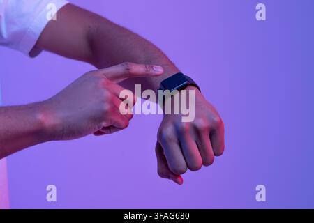 Smart devices. African man pressing button on smart watch with black screen Stock Photo