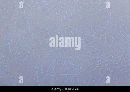 Close-up view of an abstract textured surface featuring thin, irregular light blue lines on a light grey background. The chaotic pattern creates a gra Stock Photo