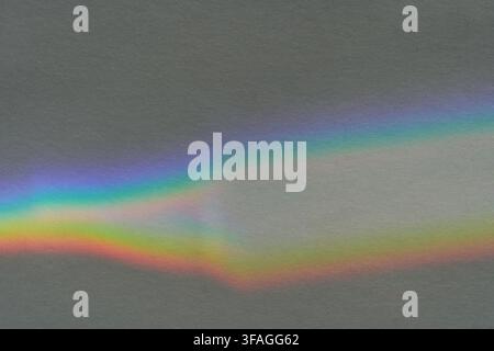 Gray Surface Crossed By Curved Rainbow Light Band With Soft Prismatic Spectrum, Showing Smooth Color Transitions And Diffuse Luminous Reflection In An Abstract Background. Stock Photo