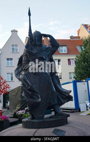 Bronze statue of Swietopelk II Great holding spear and shield on a granite pedestal in historic city center of Gdansk, Poland. Stock Photo