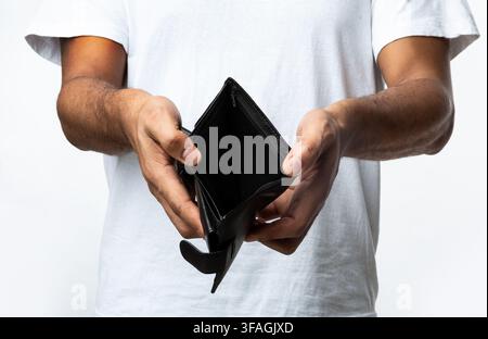 Unrecognizable Black Man Showing Empty Wallet Standing Over White Background Stock Photo