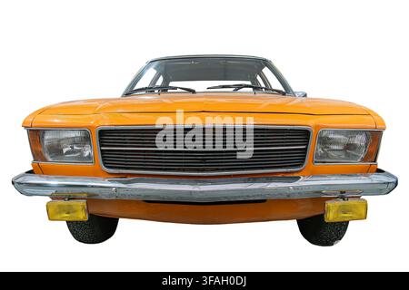 Vintage car isolated on white background, featuring sleek classic design, shiny reflective orange paint job, large chrome front grille, rectangular vi Stock Photo