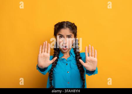 Portrait of a serious indian woman showing stop gesture Stock Photo
