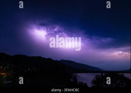 Dramatic stormy sky illuminated from behind by massive flashes of lightning, night time, southeastern France Stock Photo