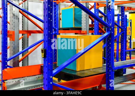 Industrial cardboard box package stored on automated racking system in smart logistics warehouse Stock Photo