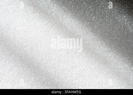 A close-up abstract view of white foam with a soft shimmering texture. Stock Photo