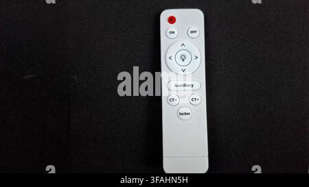 White LED Light Remote Control with Dimmable Lighting Buttons Stock Photo