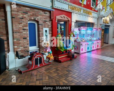 Toronto, ON, Canada - February 26, 2026: Arcade kiddie rides and claw crane game machines create a joyful and playful scene inside a mall. Stock Photo