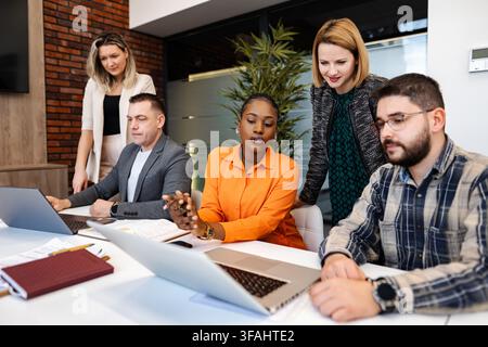 Diverse business team collaborating during an office meeting Stock Photo