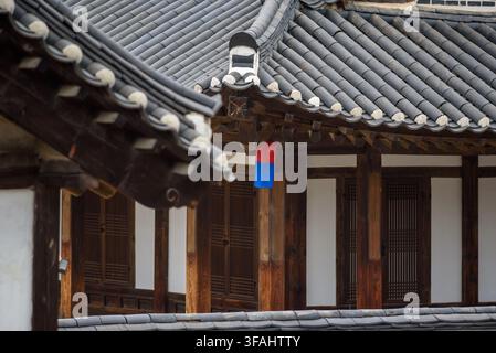 Detailed close-up image of a hanok or temple roof with dark gray tiles arranged in a wave-like pattern, decorated with interlocking tiles Stock Photo
