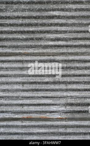 Close up of vertical corrugated galvanized tin panels with horizontal ridges with white mineral deposits Stock Photo