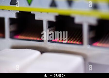 Extreme macro shot of the golden contact pins inside an empty RJ45 ethernet port on a network switch. Stock Photo