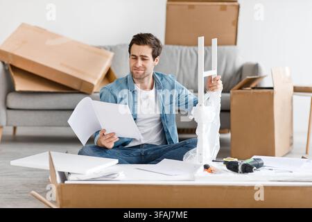Difficulties and problems in assembling new furniture at home without master Stock Photo