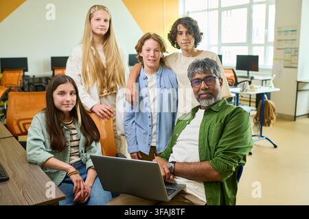 Portrait of Indian Teacher and Diverse Teenagers in Computer Class Stock Photo