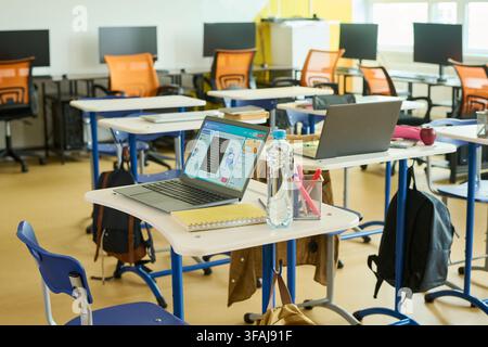 Laptops on Desks in Empty Computer Science Classroom Stock Photo