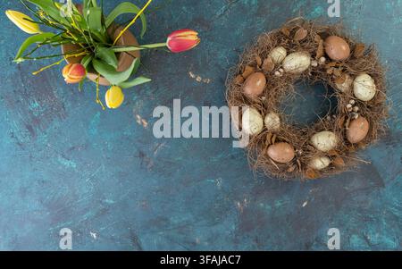 Fresh bouquet of vibrant tulips arranged on a white textured background creating a clean spring floral composition with generous copy space. Stock Photo