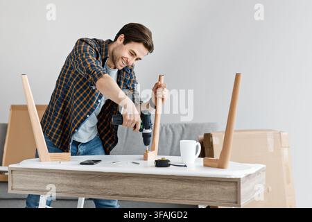 Furniture assembly using screwdriver, instrument at home, moving, home improvement, repair and renovation Stock Photo