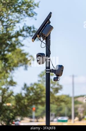 Solar powered automatic license plate reader camera installed on a suburban street pole for traffic monitoring near Georgetown Texas Stock Photo