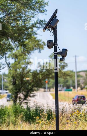 Solar powered automatic license plate reader camera installed on a suburban street pole for traffic monitoring near Georgetown Texas Stock Photo