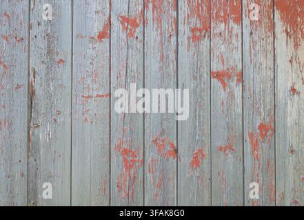 Weathered wooden planks with peeling red paint texture background. Stock Photo