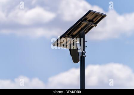Solar powered automatic license plate reader camera installed on a suburban street pole for traffic monitoring near Georgetown Texas Stock Photo