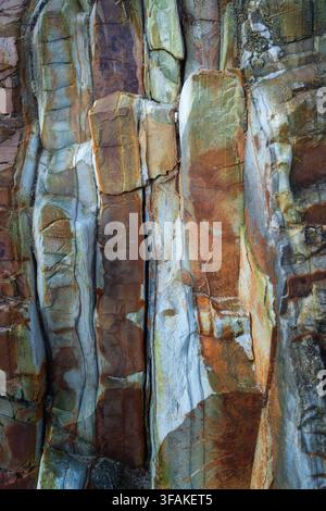 Vertical stone formation with blue tones and rusty mineral streaks. Natural geological texture ideal for abstract backgrounds. Stock Photo
