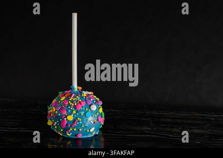 Colorful Birthday Cake Pop on a Dark Background Stock Photo