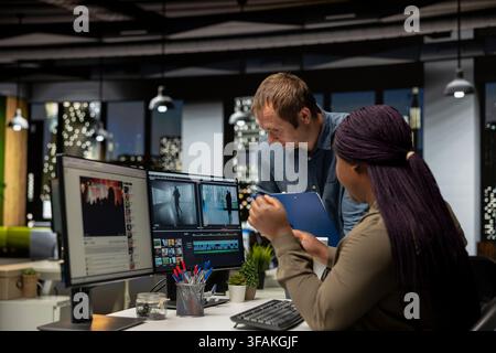 Diverse team of specialists collaborating on a film montage project, using AI chatbot and post production software for color grading. Videographers uniting forces for video content. Stock Photo