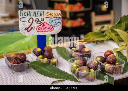 Selection of colorful freshly picked local ripe purple figs on display at a fruit stand at a farmers market in Liguria, Sanremo, Italy Stock Photo