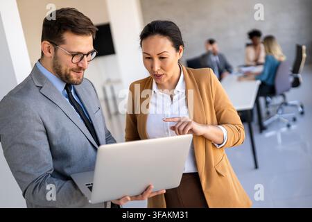 Mixed team of software engineers brainstorming ideas. Diverse app developers collaborating as group Stock Photo