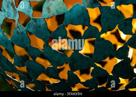A close-up detail of a dark verdigris-patinated bronze outdoor sphere sculpture, Stock Photo