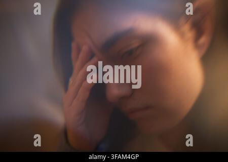 Stressed Woman Holding Head Suffering from Migraine and Anxiety Stock Photo