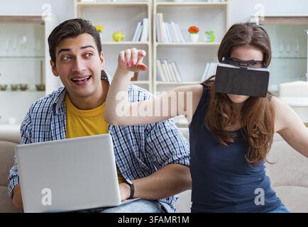 Young family playing games with virtual reality glasses Stock Photo