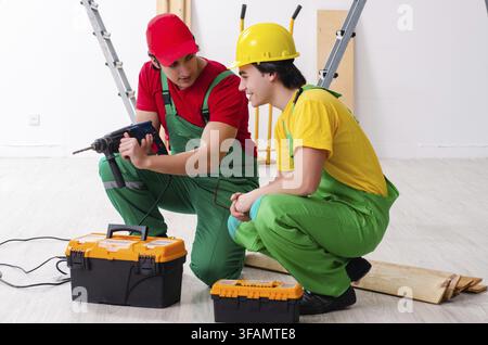 Two workers, contractors working indoors Stock Photo