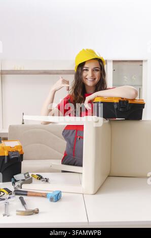 Contractor repairs furniture at home Stock Photo