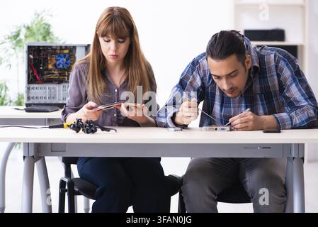 The two technicians who work in the computer warranty center Stock Photo