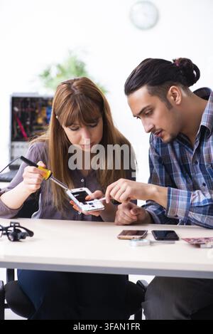 The two technicians who work in the computer warranty center Stock Photo