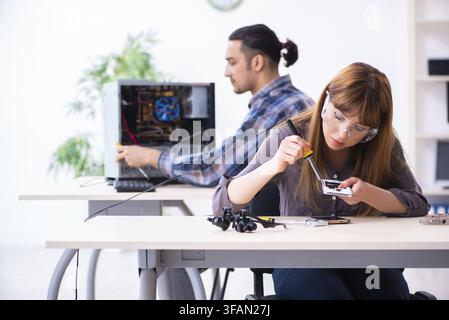 The two technicians who work in the computer warranty center Stock Photo