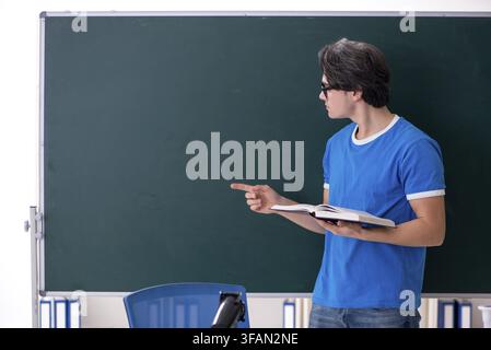 Young male student in classroom Stock Photo