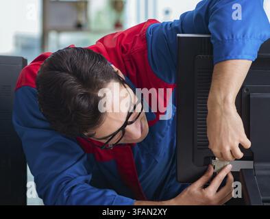 Computer mechanic works on repairing computers in an IT workshop Stock Photo