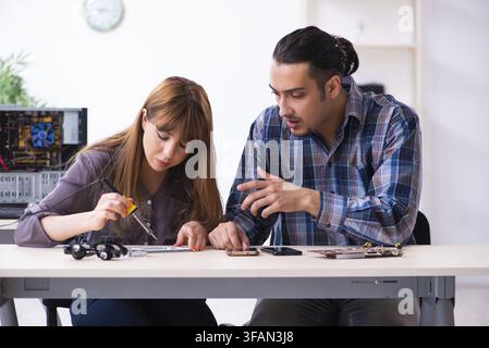 The two technicians who work in the computer warranty center Stock Photo